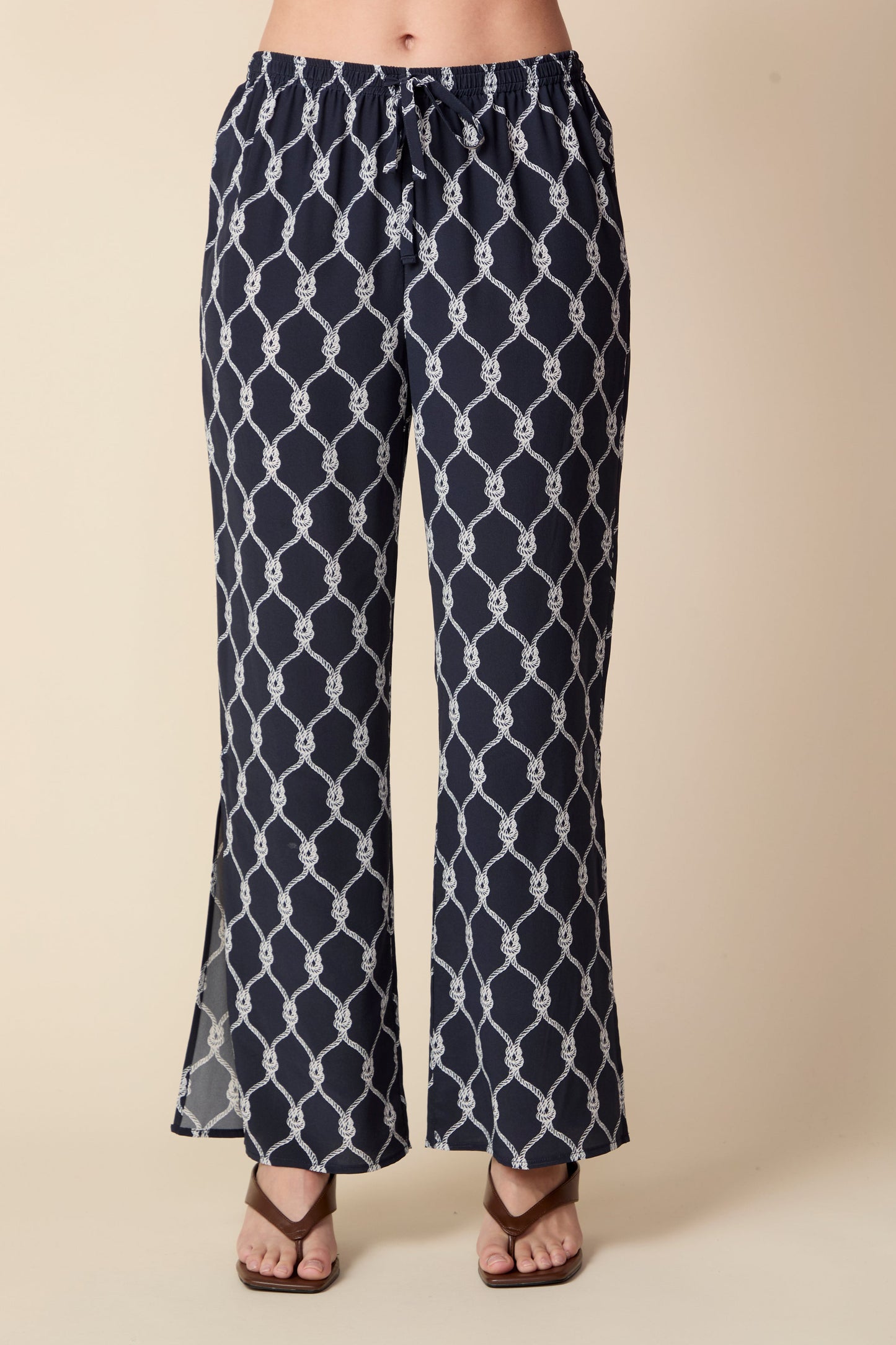 Navy blue patterned pants on a beige background