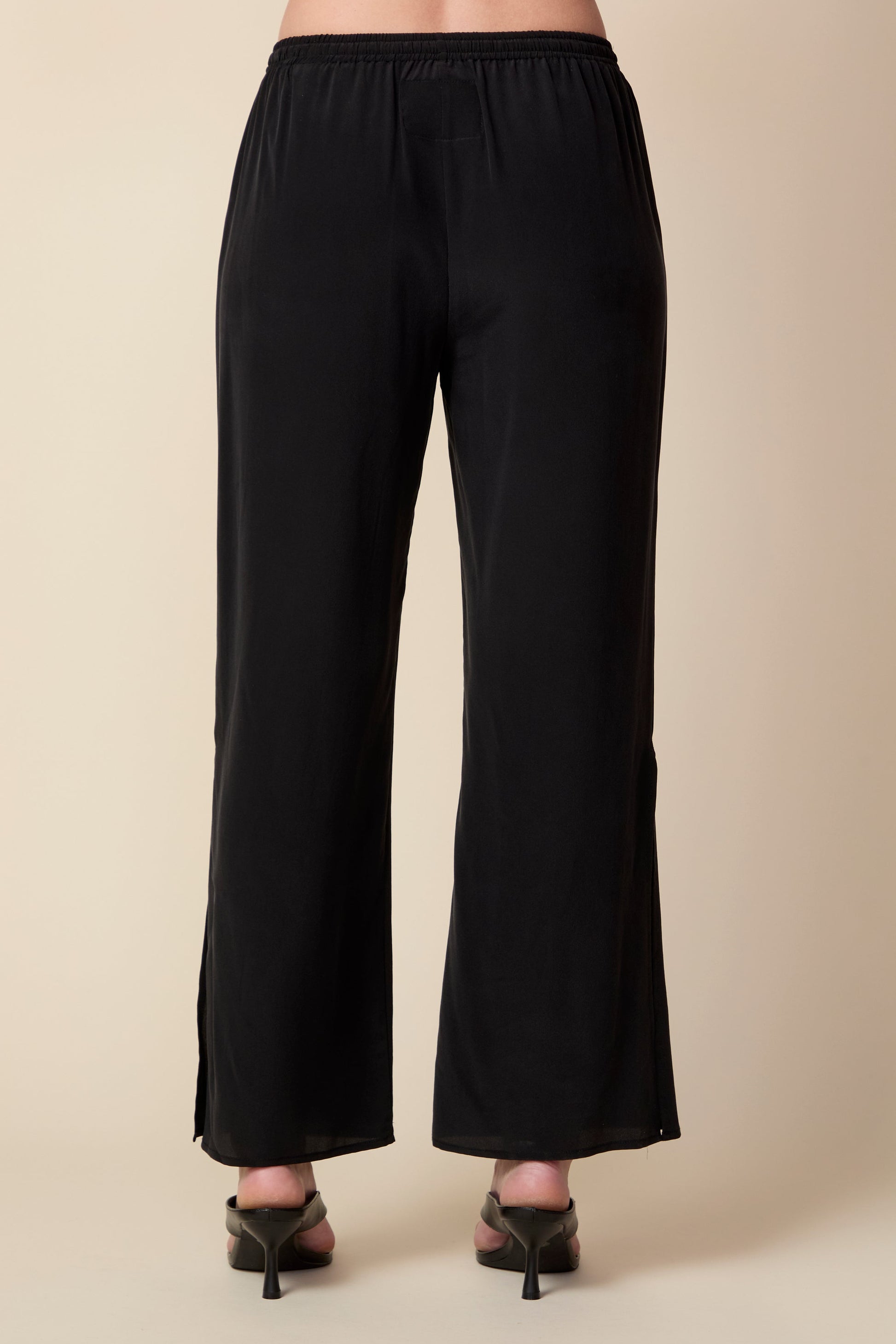 Black pants on a beige background